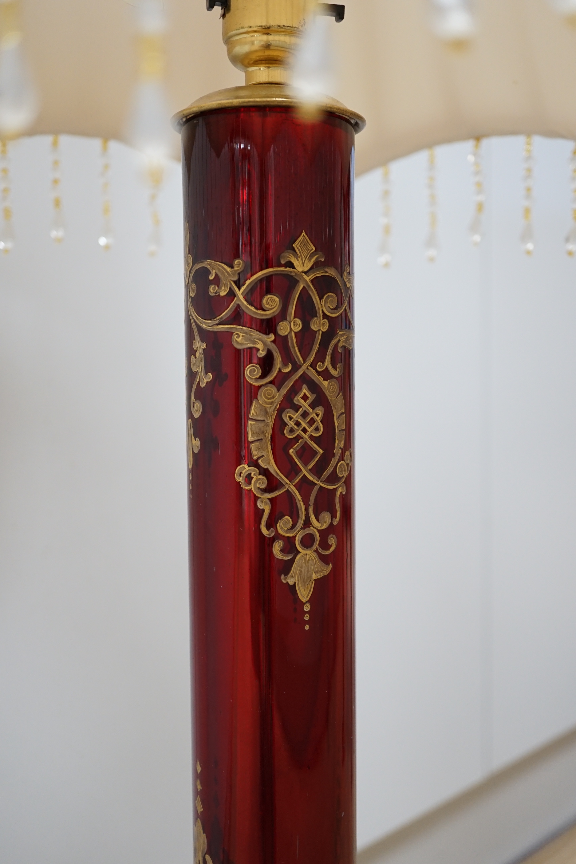 A Victorian style brass and ruby glass table lamp with shade, 81cm